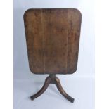 An Antique Oak Tilt-Top Table, the table having rectangular top on turned column and tripod  base,