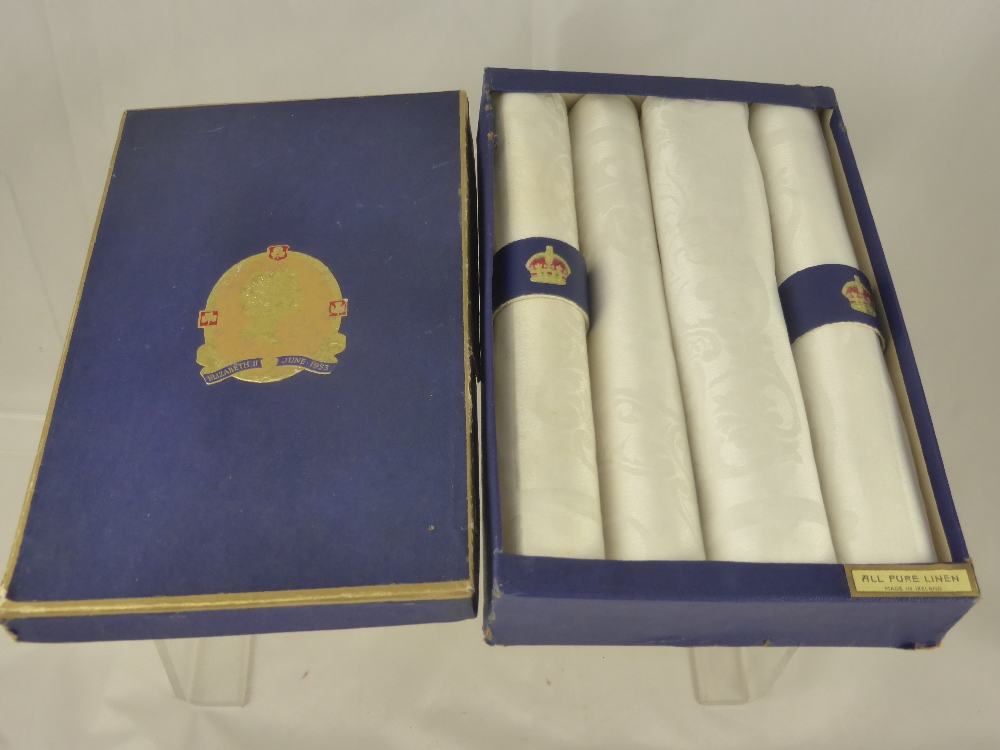 A Queen Elizabeth II Coronation Scarf, together with a set of commemorative linen napkins.