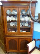 An Antique Mahogany Corner Display Cabinet. The cabinet having three shelves with shaped, glazed