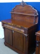 An Edwardian Mahogany Chiffonier with central drawer, on bun feet.