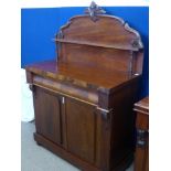 An Edwardian Mahogany Chiffonier with central drawer, on bun feet.