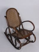 An Antique Child's Vintage Bent Wood Rocking Chair,  with cane back and seat.