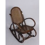 An Antique Child's Vintage Bent Wood Rocking Chair,  with cane back and seat.