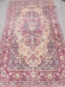 An Antique Isfahan Rug circa 1900, measuring 230 x 142 cms.