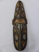 A Sepik River Papua New Guinea ceremonial mask, approx 73 cms long, trimmed with cowrie shells.
