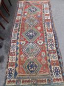 An Antique Turkish Runner, the runner having five central ghouls to inner panel with tribal motive