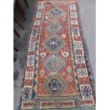 An Antique Turkish Runner, the runner having five central ghouls to inner panel with tribal motive