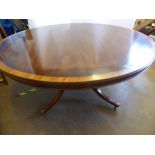 A Reproduction Mahogany and Yew Wood Inlay Circular Dining Table on four column base with brass