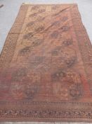 An Antique Bukhara Carpet having twelve medallions to centre, approx 350 x 190 cms together with