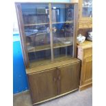 An Ercol Elm Glazed Front Display Cabinet, the cabinet having two shelves with cupboard below,