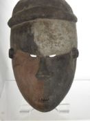 An Adolescent Sub-Saharan African Fang Mask, with ochre and kaolin decoration to mask small mouth