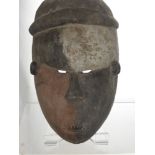 An Adolescent Sub-Saharan African Fang Mask, with ochre and kaolin decoration to mask small mouth