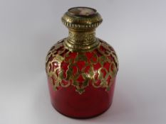 A Victorian Bohemian Ruby Tinted Glass Cylindrical Perfume Bottle, with pierced brass scroll mount