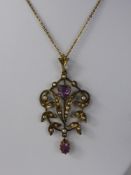 An Edwardian 9 ct Amethyst and Seed Pearl Pendant, on 9 ct gold chain, the pendant having heart
