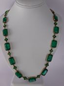 An 18th Century Style 9 ct Gold Faux Emerald Glass and Enamel Necklace. The necklace having eighteen
