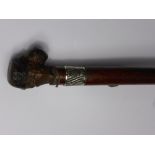 An Unusual Walking Cane, with knop carved as a grotesque face with inset glass eyes with silver