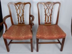 Four Heavy Chinese Fruit Wood Dining Chairs, including two carvers, with carved backs and straight