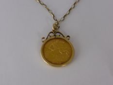 An Edward VII 1910 Half Sovereign in 9 ct mount on 9 ct gold chain (9 ct approx 2.5 gms).