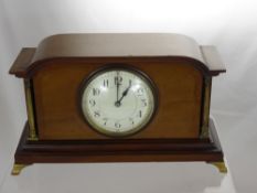 A Mahogany Mantel Clock, with brass pillar supports, cream enamel dial.