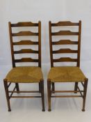 Four Ladder Back Rush Seat Dining Chairs, on straight legs with stretchers.
