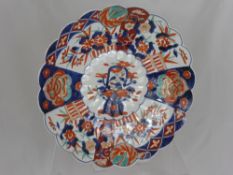 An Antique Imari Plate, having scalloped edge and decorated with flowers, approx 39 cms dia.