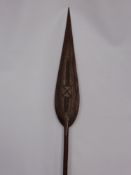 A Polynesian Spear Paddle, the paddle carved with tribal decoration.