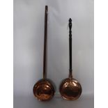 Two Copper Warming Pans, together with a pair of brass candlesticks Reg. No. 2253 and a hammered