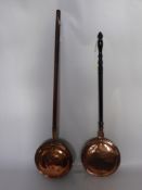 Two Copper Warming Pans, together with a pair of brass candlesticks Reg. No. 2253 and a hammered