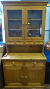 A Pine Kitchen Dresser, with spice drawers beneath two glazed cupboards with two drawers and