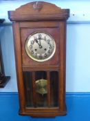 An Edwardian Oak American Style Long Wall Clock, the clock having three bevelled glass panels to