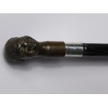 An Ebonised Walking Cane, with large bronze Negro's head (detachable, unscrews) with silver collar