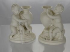Two Worcester Kerr & Binns Parian Figures in the form of putti seated beside ewers. (2)