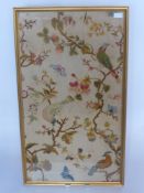 An Embroidered Panel depicting birds and butterflies, approx 84 x 46 cms, framed and glazed.