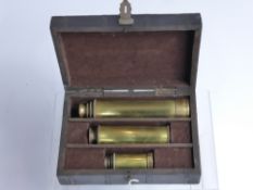Three Small Brass Telescopes, in metal banded fitted case.