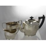 A Silver Tea Trio, comprising tea pot, milk jug and twin handled sugar bowl, Birmingham hallmark, mm