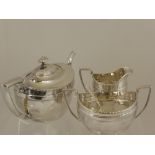 A Silver Plated Art Deco Style Tea Trio, comprising tea pot, milk jug and sugar bowl.