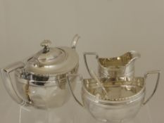 A Silver Plated Art Deco Style Tea Trio, comprising tea pot, milk jug and sugar bowl.