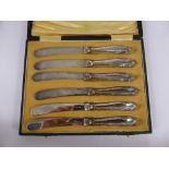 A Set of Silver Handled Butter Knives, together with a silver metal tot measure. (2)