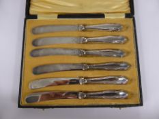 A Set of Silver Handled Butter Knives, together with a silver metal tot measure. (2)