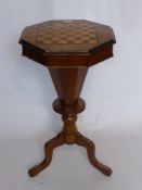 An Octagonal Walnut/Mahogany Inlaid Sewing/GamesTable, the sewing box on tripod base.