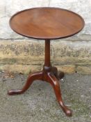 An Antique Mahogany Wine Table, tripod base, turned column and hoof feet, approx 45 x 55 cms.