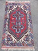 A Middle Eastern Woollen Rug, having central ghoul  and geometric design, approx 186 x 120 cms.
