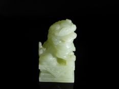 Chinese 20th Century Pale Celadon Jade Foo Dog, the figure featuring an ornately carved mane and