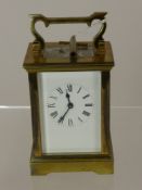 A Brass Carriage Clock with white enamel face and Roman dial, movement stamped A.C.G., approx 15 x 8