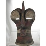 A Sub-Saharan African Tribal Mask, the ochre and kaolin mask depicting half-man,  half-beast, with