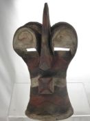 A Sub-Saharan African Tribal Mask, the ochre and kaolin mask depicting half-man,  half-beast, with