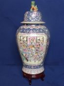 Chinese Famille Rose Temple Vase and Cover, the vase featuring a cobalt blue ground interspersed