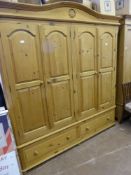 A Pine Double Wardrobe with four folding doors, two drawers beneath.