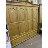 A Pine Double Wardrobe with four folding doors, two drawers beneath.