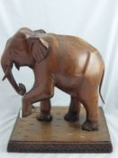A Carved Figure of an Elephant, in wood, approx 41 x 30 x 45 cms.